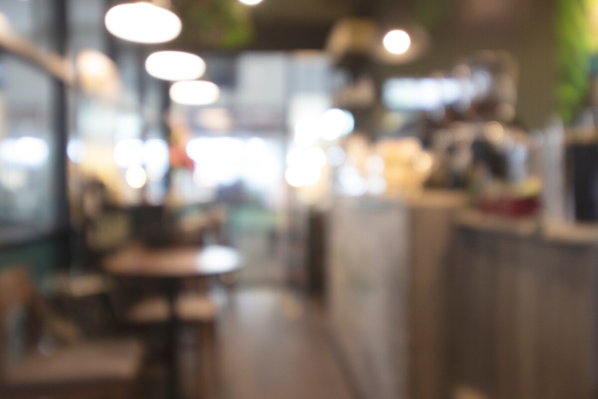 Blurred indoor café setting representing everyday environments where clear vision matters.