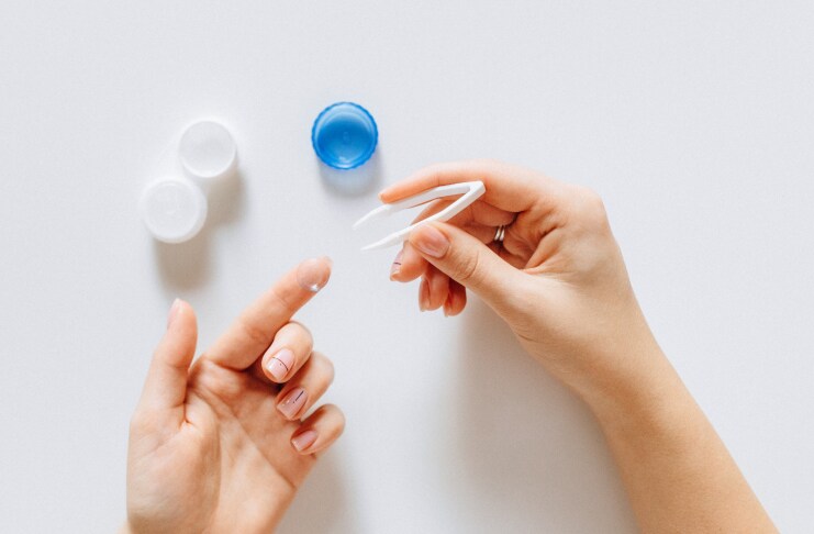 person-holding-contact-lens-on-index-finger