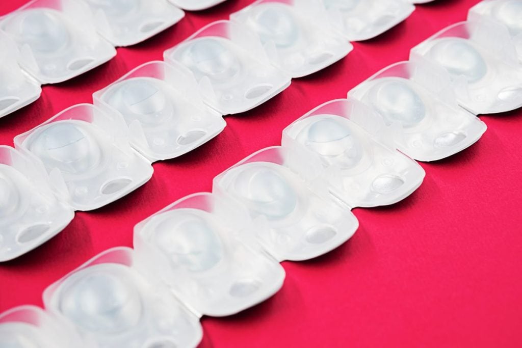contact-lens-blister-packs-on-red-background