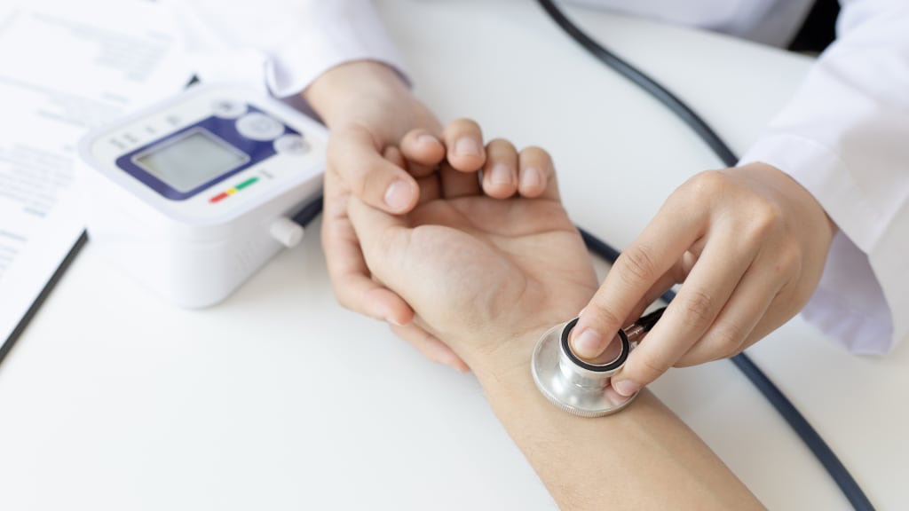 doctor-taking-patient-blood-pressure