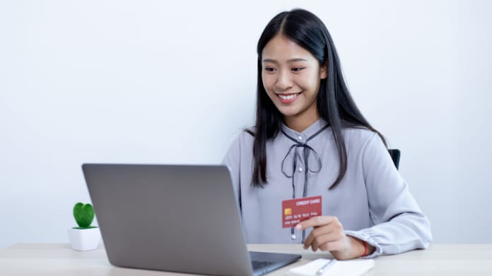 woman-online-shopping-using-a-laptop-and-a-credit-card