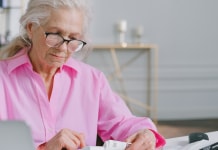 elderly-woman-looking-at-documents