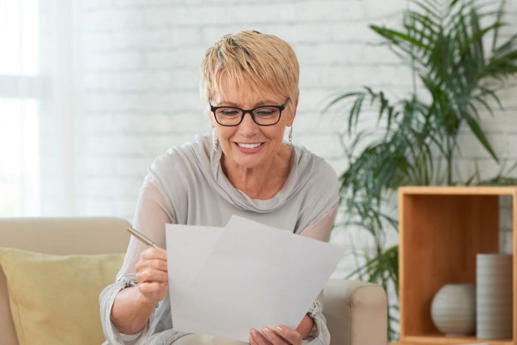 senior-woman-reading-document-with-glasses