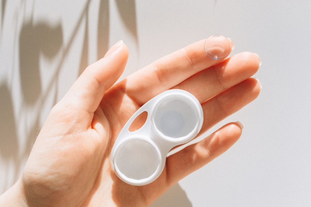 a-person-holding-contact-lens
