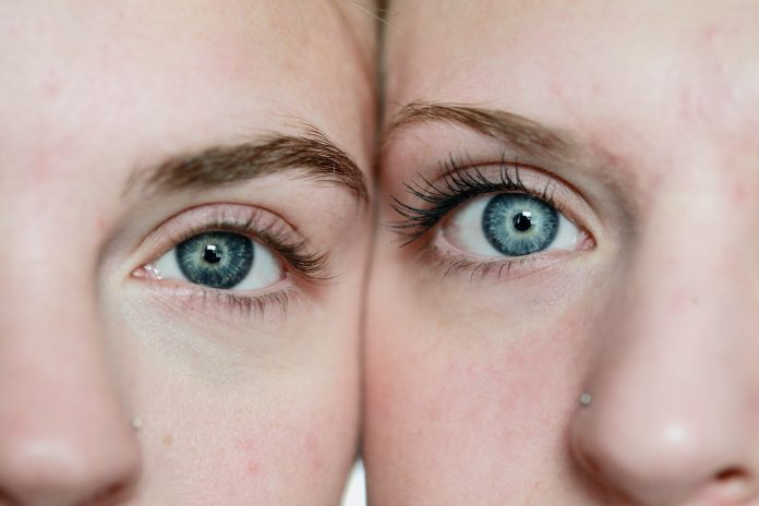 Two women wearing colored contacts.