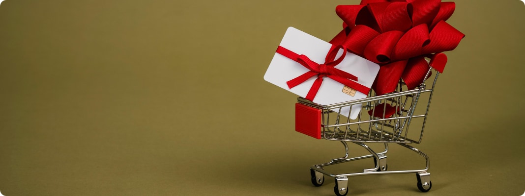 Shopping cart carrying Christmas gifts.