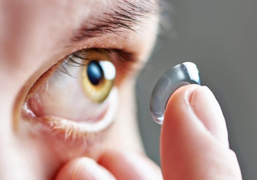 Close-up of a person putting on a contact lens